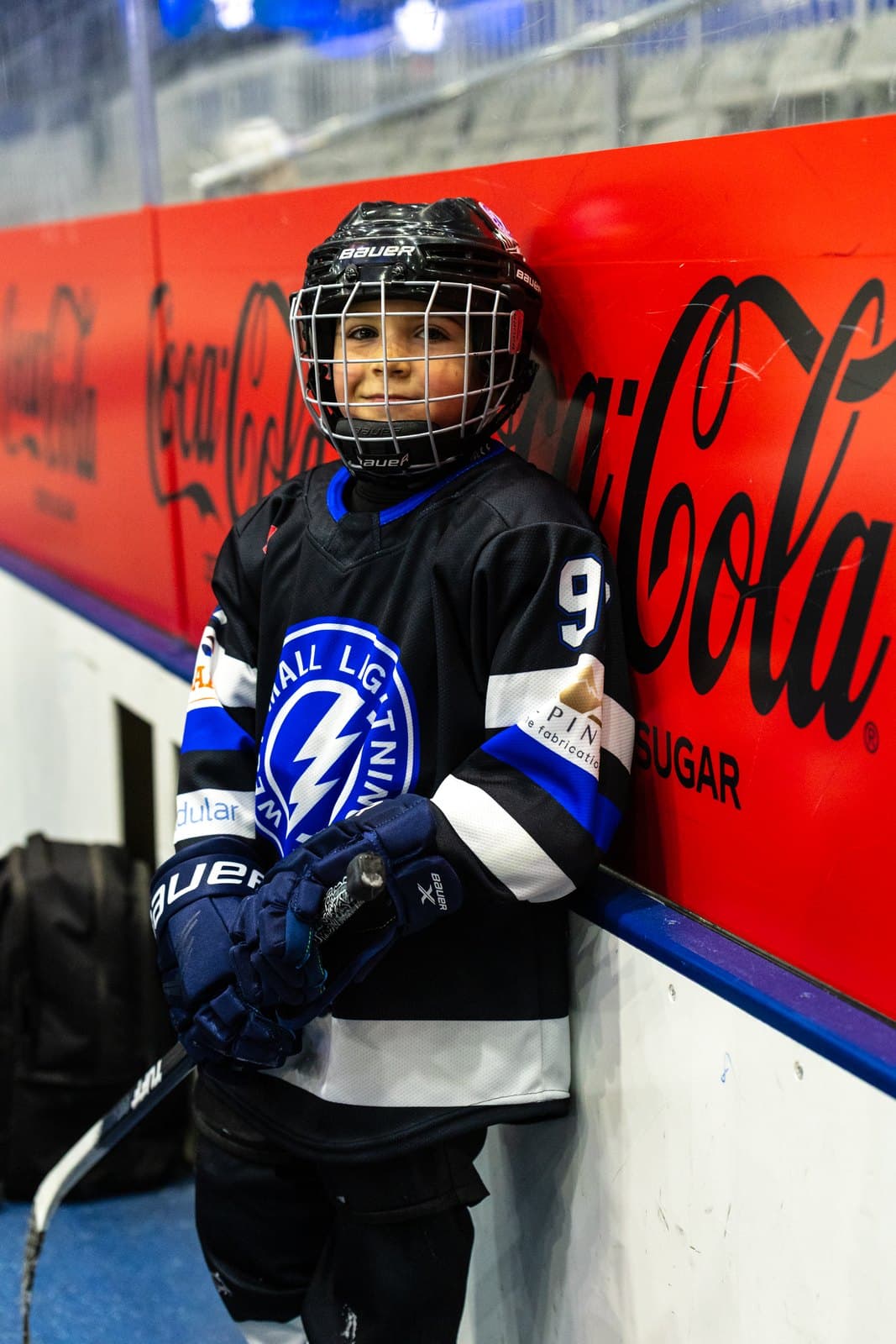 Portrait of a player standing against the arena boards