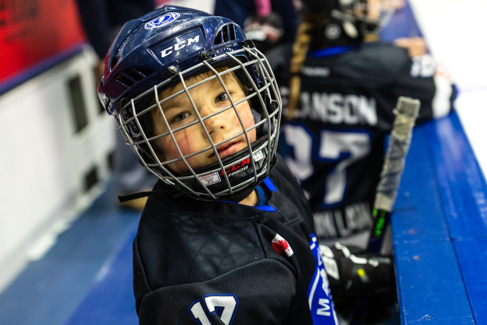Close portrait of a player at the boards between shifts, cage up close