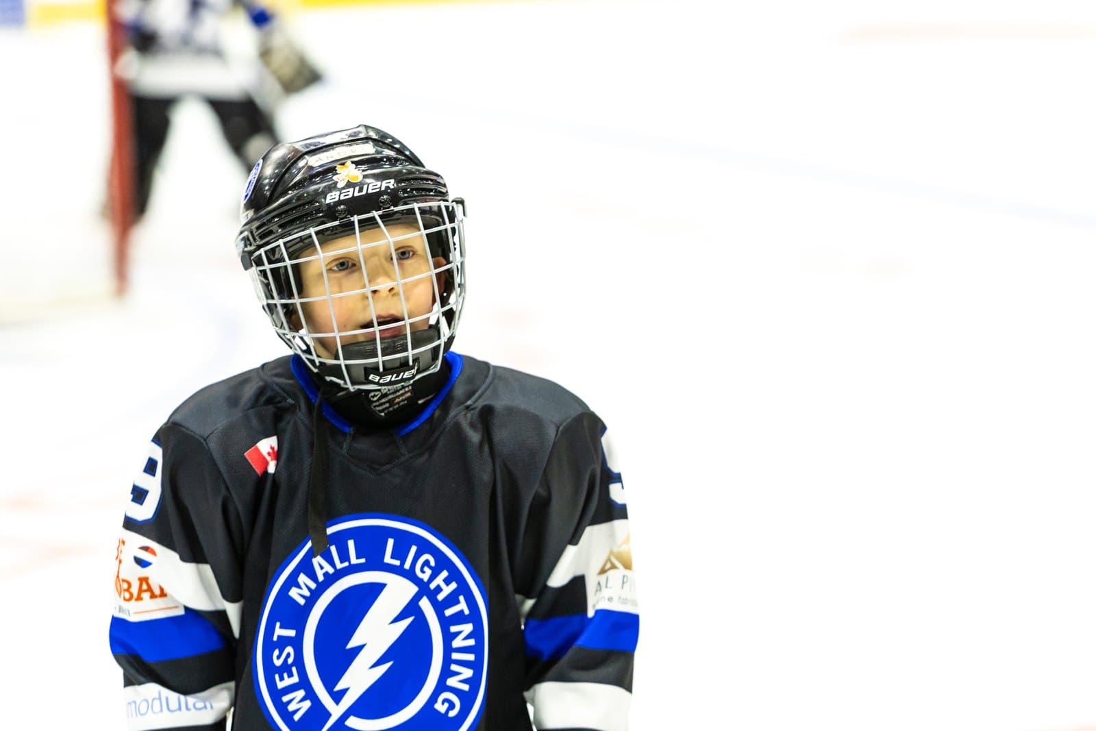 Portrait of a player standing at centre ice, looking into the camera
