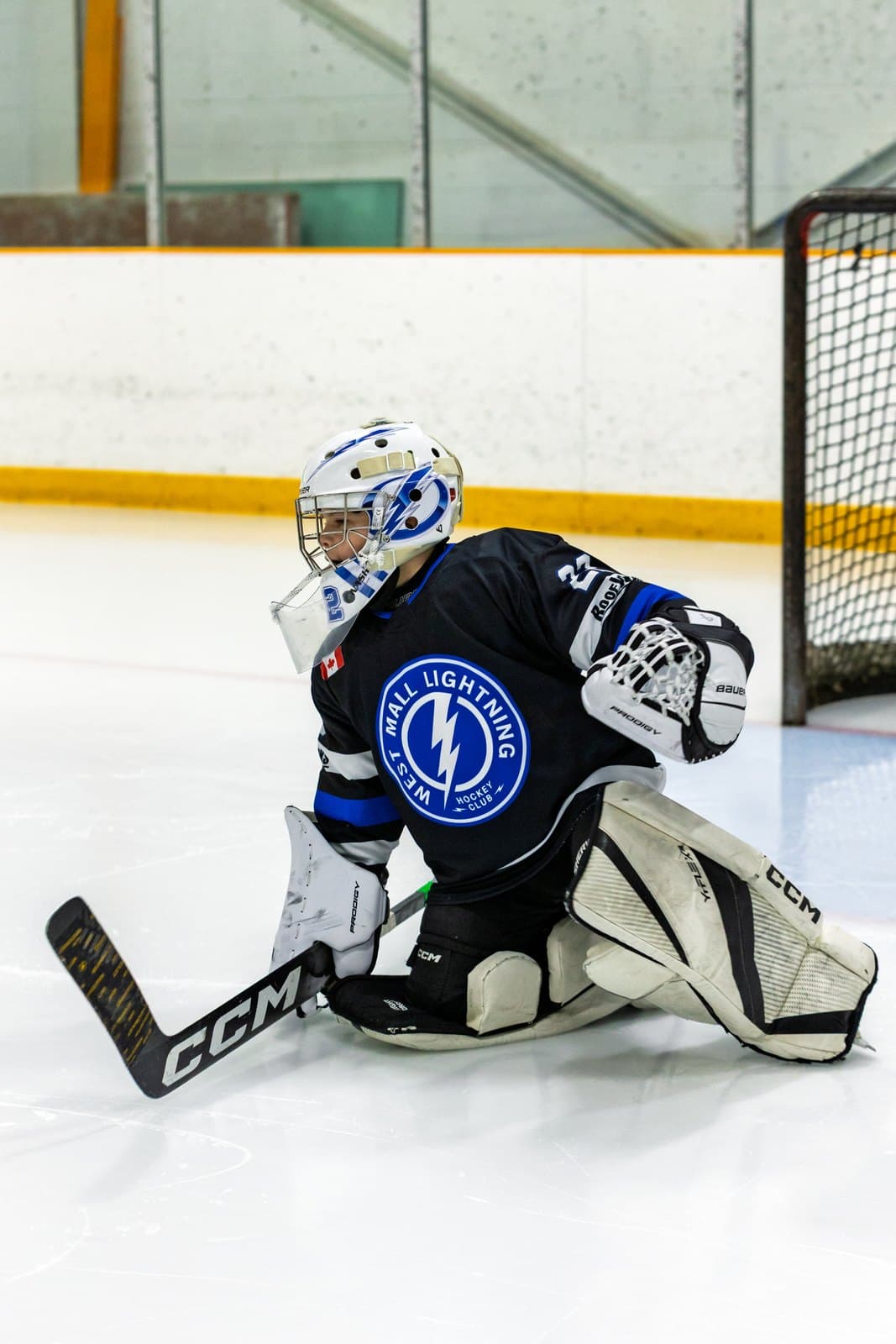 Butterfly save to the glove side, pads flared across the goal line