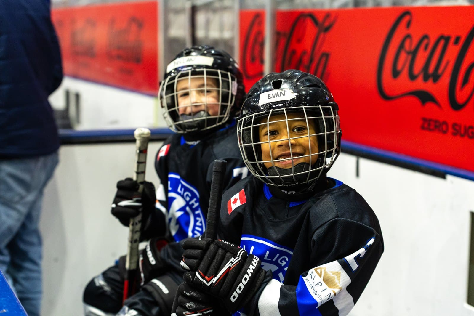 Two players leaning on the boards, taking a breather