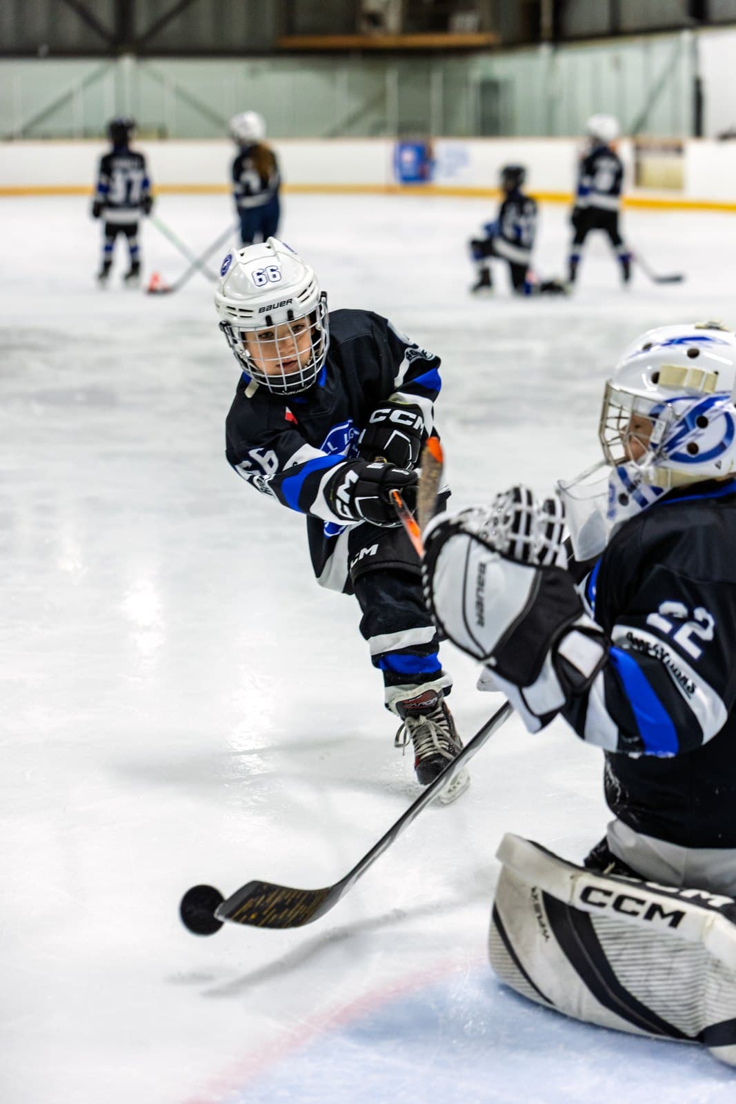A shot released through the slot with the goaltender dropping into the save
