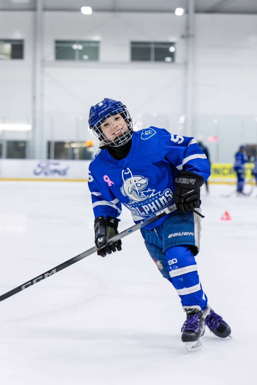 A skater stickhandles into open ice, eyes up the sheet