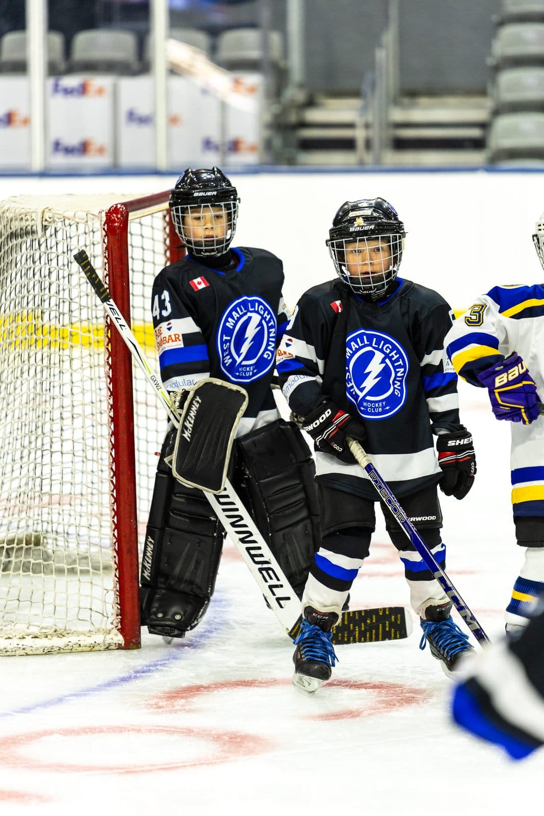 A group of teammates posed together in front of the net