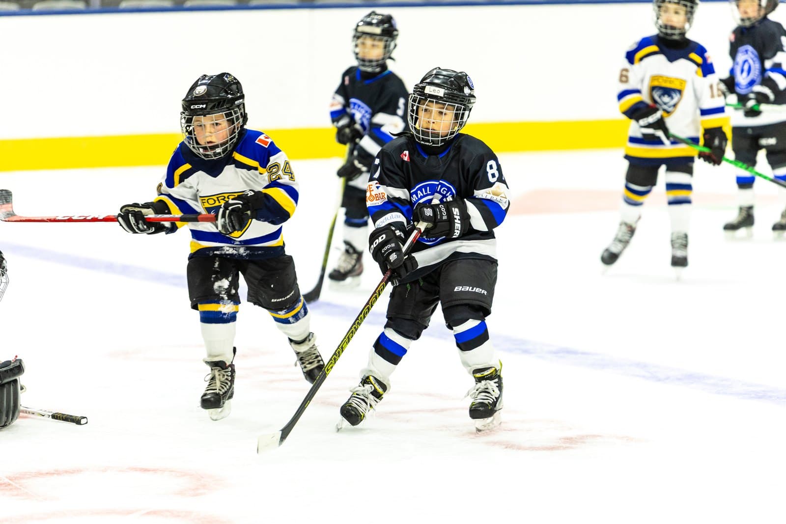 A full line of skaters moving up the ice together