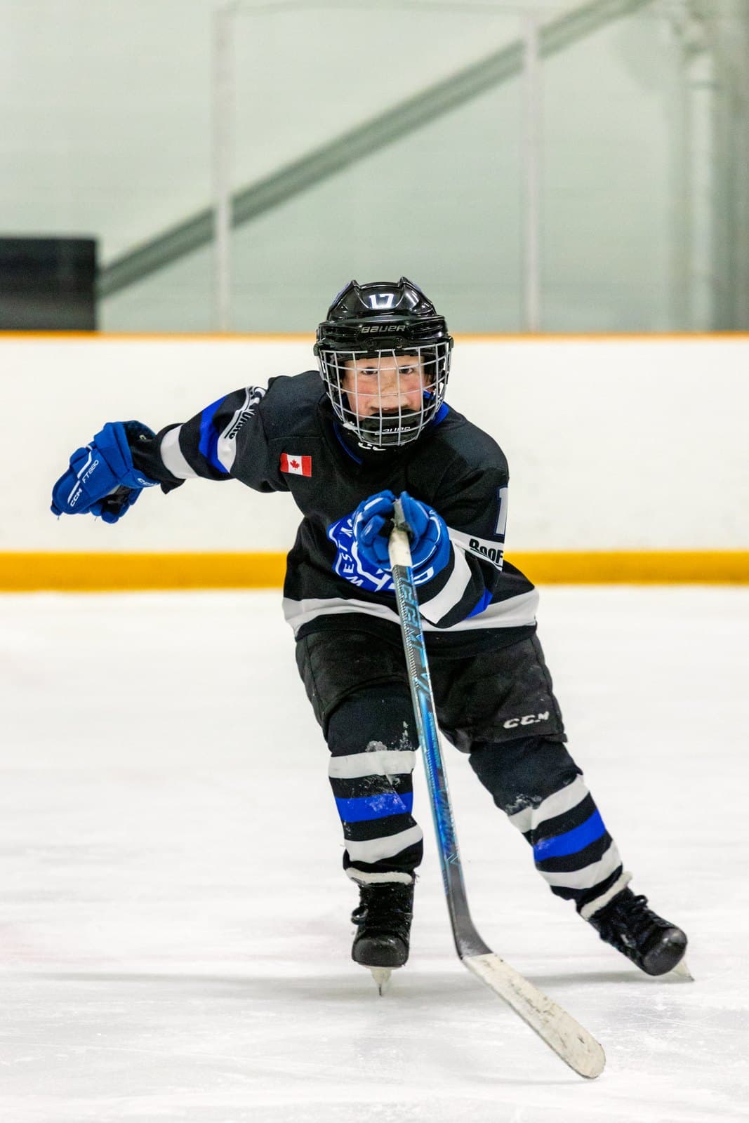A tight turn in open ice, arms wide for balance